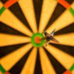black dart pink attach on yellow green and red dart board