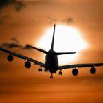 shadow image of a plane flying during sunset