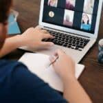 man in blue shirt having a virtual meeting